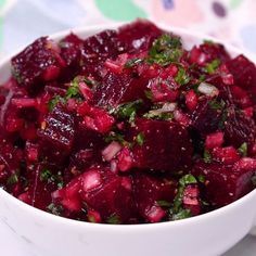 a white bowl filled with beets on top of a table