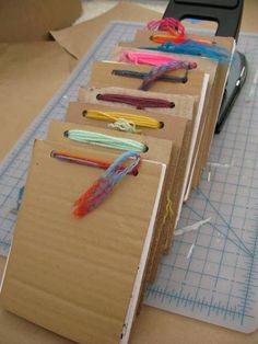 several pieces of craft paper are lined up on a table with scissors and crochet hooks