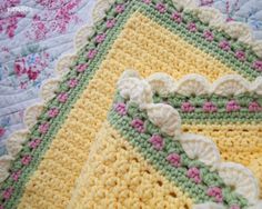 three crocheted afghans are laying on top of each other, one is yellow and the other is green