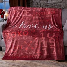 a living room with a couch, chair and table covered by a red blanket that says we hope us