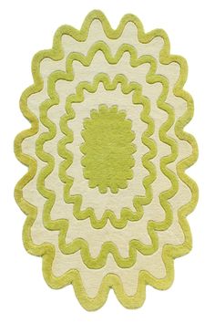 a green and white rug with an intricate design on the center, in front of a white background