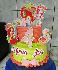 a three tiered birthday cake with the number four on it's top and decorations