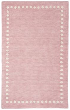 a pink rug with white dots on it