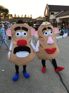 two people in costumes standing on the street