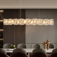 a modern chandelier hanging over a dining room table