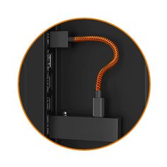 an orange cable connected to a black wall mounted device with a white and yellow circle around it