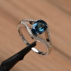 It is London blue topaz ring, the main stone is about 6mm*8mm, oval cut, weight about 1.47 carats.The basic metal is sterling silver and plated with rhodium.To change the metal to a solid gold (white/rose) or platinum is also available, please ask for a quotation if you want.You can also go to my shop Home for more elegant rings: https://www.etsy.com/shop/godjewelry?ref=hdr_shop_menuLondon blue topaz is November birthstone.More London blue topaz rings:https://www.etsy.com/shop/godjewelry?ref=sel Elegant Oval Solitaire Topaz Ring, Elegant Oval Blue Topaz Birthstone Ring, Anniversary Oval Blue Topaz Diamond Ring, Oval Blue Topaz Ring In White Gold, Classic Oval Topaz Birthstone Ring, Classic Oval Topaz Ring, Topaz Solitaire Birthstone Ring Oval, Oval Solitaire Topaz Ring In White Gold, Oval Topaz Birthstone Ring In Sterling Silver