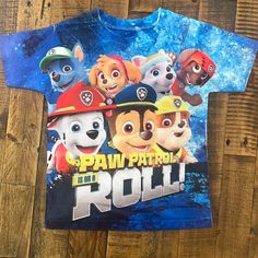 “Paw Patrol On A Roll” Jersey Fabric T Shirt, Never Worn. Size 6, Appropriate Sizing For 5/6 Year Olds Casual Printed T-shirt For Playtime, Casual Printed T-shirt For Play, Casual Blue Tops For Play, Blue Fun Top For Play, Blue Printed Tops For Playtime, Multicolor Cartoon Print T-shirt For Playtime, Multicolor Shirt With Graphic Print For Playtime, Playful Blue Shirt With Character Print, Multicolor Graphic Print Shirt For Playtime