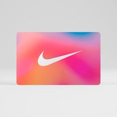 a nike credit card sitting on top of a white table next to a pink and blue background