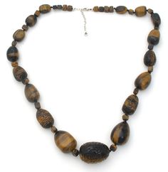 Statement Jewelry - This is a substantial vintage knotted brown tiger's eye sterling silver necklace with fabulous hand carved beads. It is 30" long, which includes the 2.5" extension, so necklace can be worn from 27.5" to 30" in length. Beads are hand knotted and vary from slightly over .25" to 1.25" in diameter. It is hallmarked 925, weighs 300 grams and signed Barse. Brown Carved Round Beads Necklaces, Brown Carved Round Bead Necklaces, Adjustable Carved Brown Necklace, Brown Jewelry With Oval Wooden Beads, Brown Wooden Beads Oval Jewelry, Brown Wooden Oval Beads Jewelry, Brown Oval Beaded Necklaces Hand-strung, Brown Oval Beaded Hand-strung Necklaces, Brown Oval Beaded Hand-strung Necklace