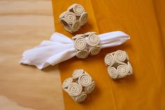 three napkin rings and two napkin holders on a table