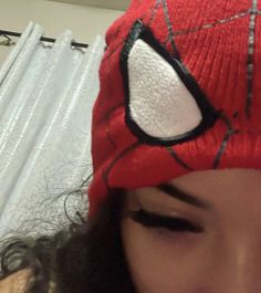 a close up of a person wearing a spiderman hat