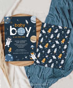 a baby boy is on the way card with space themed background and matching blue blanket