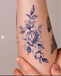 a woman's arm with a flower tattoo on the left side of her body