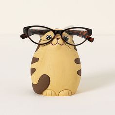 a wooden cat with glasses on it's head