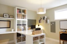 a home office with shelves, desk and computer