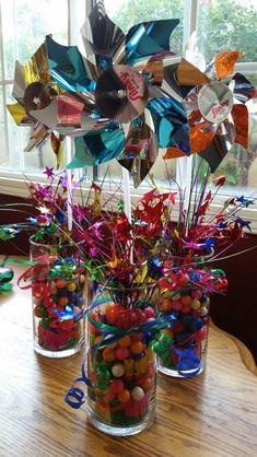 two vases filled with candy sitting on top of a table