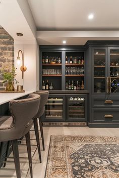 an elegant home bar with built - in wine coolers