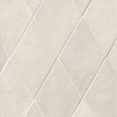 a white tile wall with diagonal lines on it