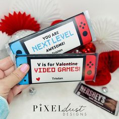 two valentine's day video games are being held by someone