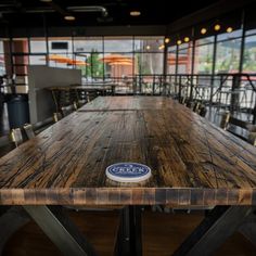 a wooden table sitting inside of a restaurant