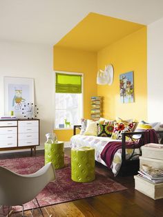 a living room with yellow walls and furniture