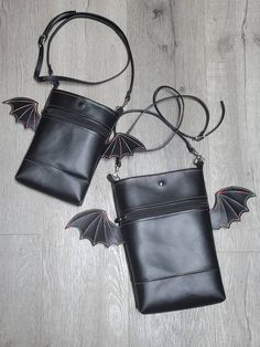 Batty crossbody market bags black vegan vinyl gothic accessories rainbow alternative clothing halloween purse wings MINI IS APPROX 8X6.5 MAXI IS APPROX 11X 8.5 both have black linings inside pocket and inside main bag. Bag has 1 zipper pocket and a top snap style closure  Comes with black adjustable vinyl strap Listing is for one bag of your size choice.  These are made to order Black Edgy Shoulder Bag For Halloween, Black Shoulder Bag For Halloween Cosplay, Gothic Black Shoulder Bag For Festivals, Black Zipper Closure Shoulder Bag For Halloween, Alternative Style Black Bags For Festivals, Black Shoulder Bag With Zipper For Alternative Fashion, Black Shoulder Bag For Alternative Fashion With Zipper Closure, Gothic Accessories, One Bag