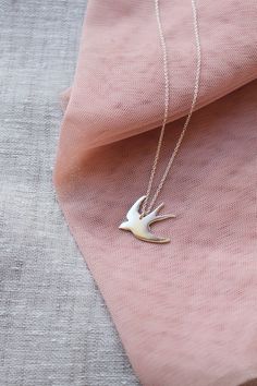 This sterling silver swallow necklace is a beautiful & feminine must have piece!Oh so pretty!— d e t a i l s —-swallow pendant measures 2.5 x 2.5cm-hand sawn from sterling silver-completed in a mirror finish-includes a 45cm silver chain-All Lola&Cash jewellery will arrive in gift giving mode>>>——————————<<<>>>——————————<< Elegant Silver Necklace With Bird Shape, Sterling Silver Bird Necklace, Silver Bird-shaped Sterling Silver Necklace, Swallow Jewelry, Swallow Necklace, Tarnished Silver, Gift Toppers, Bird Necklace, Bird Jewelry