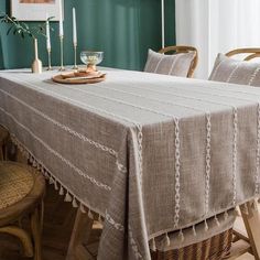 a dining room table with two chairs and a basket on it