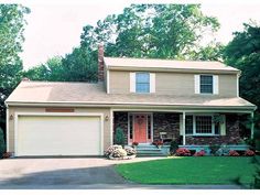 a large house with two garages in the front yard