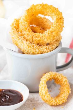 fried onion rings in a cup with dipping sauce