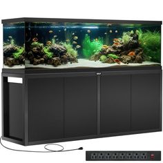 an aquarium with many different types of fish in it and a remote control on the side