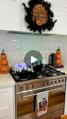 a stove top oven sitting inside of a kitchen under a happy halloween sign on the wall