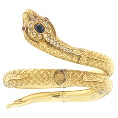 Beautiful 18 karat yellow gold snake bracelet mounted with natural diamonds,sapphire on the head and rubies in the eyes note that the bracelet can be adapted to any wrist size as shown in the video. Snake-shaped jewels always have a particular charm and denote grace, seduction and mystery. In many civilizations, in fact, the snake has had very important meanings, often ambivalent, with references to life and death, good and evil. This is probably linked to the very nature of this animal which us Snake Bangle, Snake Bracelet, Gold Snake, The Snake, Good And Evil, Bangle Bracelet, New Life, Natural Diamonds, Cuff Bracelets