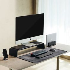 a computer monitor sitting on top of a desk next to a keyboard