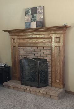 a living room with a fire place and a painting on the wall above it's mantle