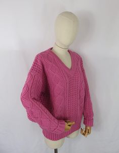 a mannequin with a pink sweater on it