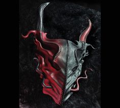 a red and black mask with long horns