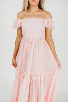 This dress will let your inner princess shine through! Meet the Bella, the dreamy, tulle-layered ballgown we're all obsessing over. This beauty is light as air and destined for the dance floor; from its square neckline and ruffled cap sleeves, to its voluminous multi-tiered tulle skirt, the Bella will capture everyone's attention when you walk in the room. Just don't forget your glass slippers! Available in four colorways. FIT: Runs true to size. Your true size will accommodate most early-to-mid maternity. MATERIAL: 100% Polyester. GARMENT DETAILS: Lightweight, flounced maxi dress with layered tulle construction. Features square neckline, ruffled cap sleeves, and a voluminous, beautifully draped skirt with layers of tulle and multiple tiers. Features a smocked back panel and full lining. S Flowy Tulle Dress For Party, Elegant Spring Fairy Dress For Bridesmaids, Elegant Fairy Dress For Bridesmaids In Spring, Organza Dress For Debutante Ball In Spring, Princess Style Tiered Tulle Dress, Tiered Dresses For Debutante Ball, Elegant Summer Fairy Dress With Tulle Skirt, Flowy Tulle Maxi Dress, Pink Maxi Tulle Skirt Dress