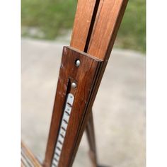 a close up of a wooden chair with metal handles