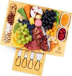 a wooden cutting board topped with lots of different types of food