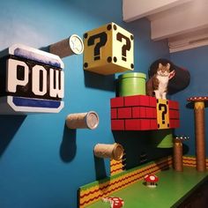 a cat sitting on top of a shelf in a room with toys and other items