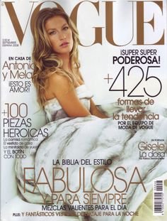 a woman laying on top of a bed in a white dress next to a magazine cover