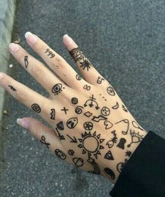 a person's hand with tattoos on it