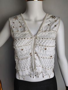 PS COMPANY vintage women's crochet beaded vest Very good used condition Size tagged 38 (D), 12 (GB), 40 (F), 44 (I), fits like XS (please check measurements) Composition: 100% cotton Measurements: Pit to pit - 15″ / 38 cm Back length - 15″ / 38 cm *All measurements are taken with the garment laying flat #2435 Embellished Bohemian Sleeveless Vest, Traditional Embellished Sleeveless Tops, Fitted Bohemian Vest For Festive Occasions, Bohemian Sleeveless Top For Festive Occasions, Festive Bohemian Vest, Sleeveless Crochet Trim Top For Party, Sleeveless Crochet Top With Crochet Trim For Party, Bohemian Crochet Top With Crochet Trim For Party, Sleeveless Crochet Top For Party