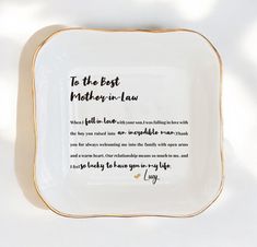 a white and gold plate with the words to the best mother in law on it