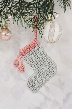 a crocheted stocking hanging from a christmas tree