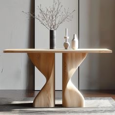 a wooden table with two vases on it and a rug in front of it