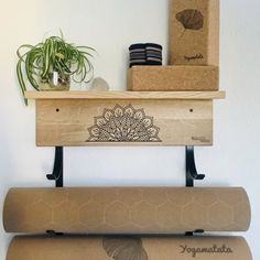 two yoga mats sitting on top of each other in front of a wall mounted shelf