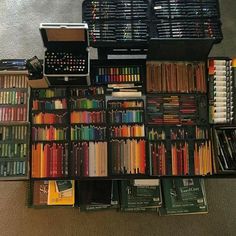 many different colored pencils are arranged on the floor next to each other in boxes